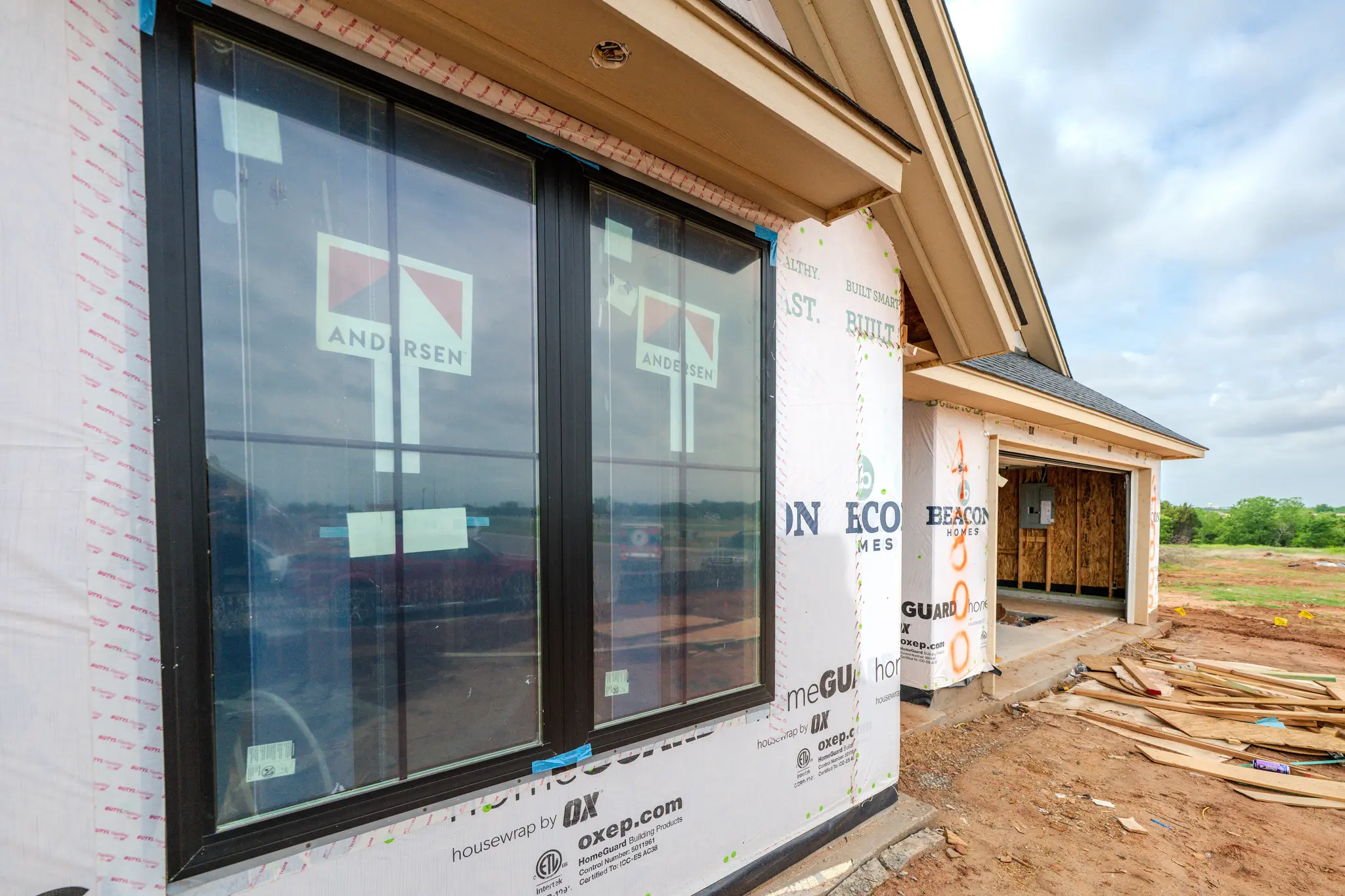 Blog post image: Tyvek moisture barrier wrapped Beacon home with sealed windows in Edmond, Oklahoma.
