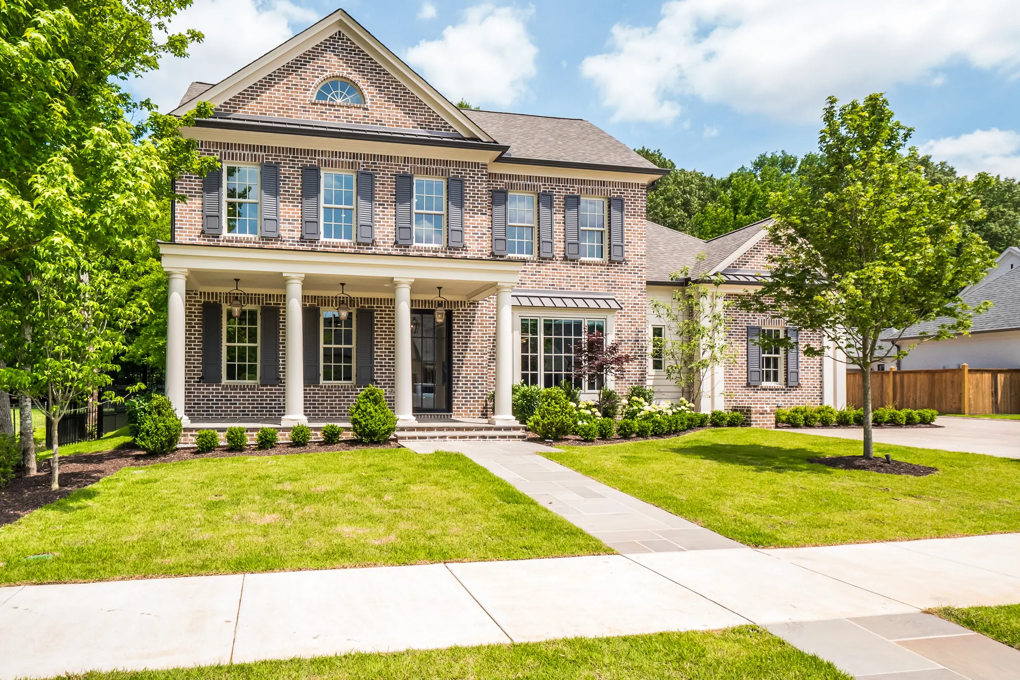 exterior of a quality-built magnolia home, with intentional craftmanship, on a sunny, spring day