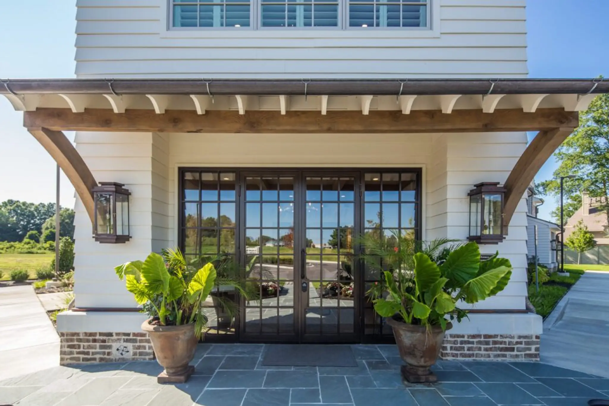 Magnolia Homes Design Center stunning double iron front doors with blue ice stone flooring.