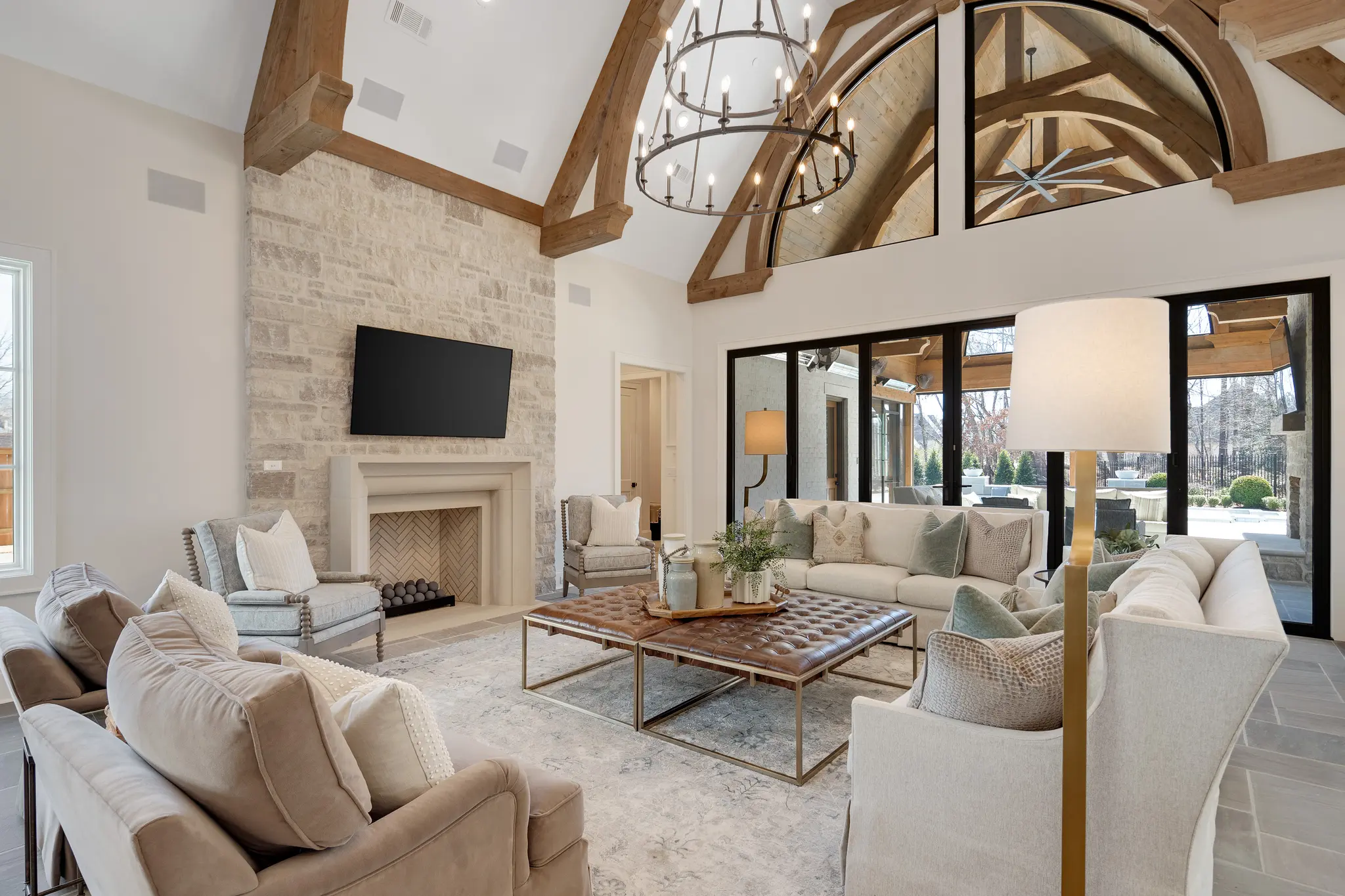 Stunning interior family room with huge ceiling beams, cozy fireplace, and comfortable seating
