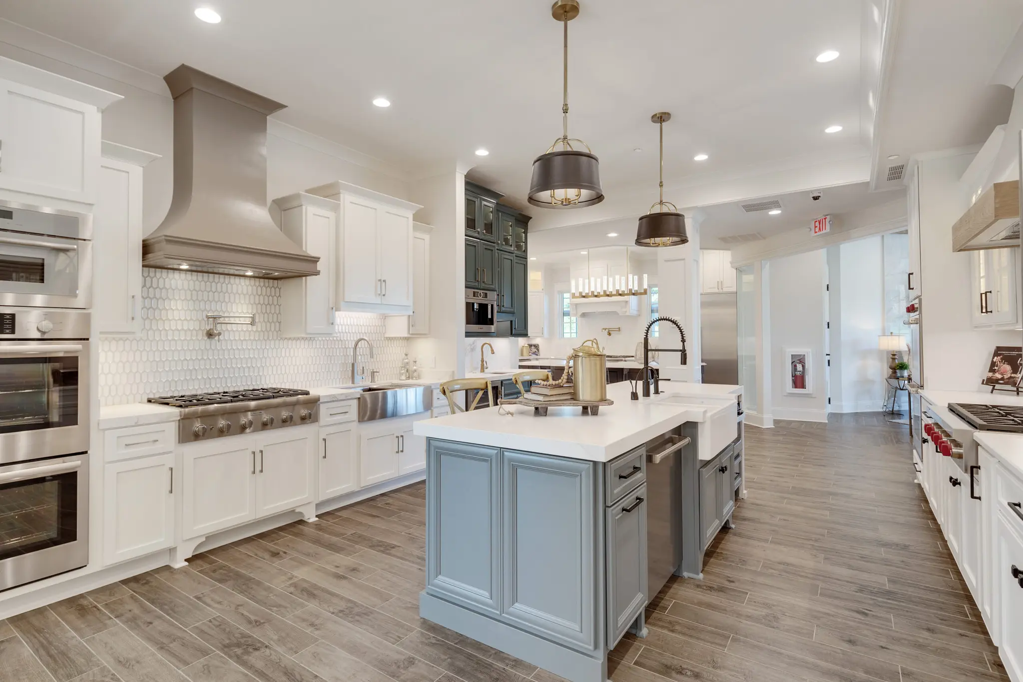 Magnolia Homes Design Center display of a stunning kitchen with variety of cabinet styles and colors. 