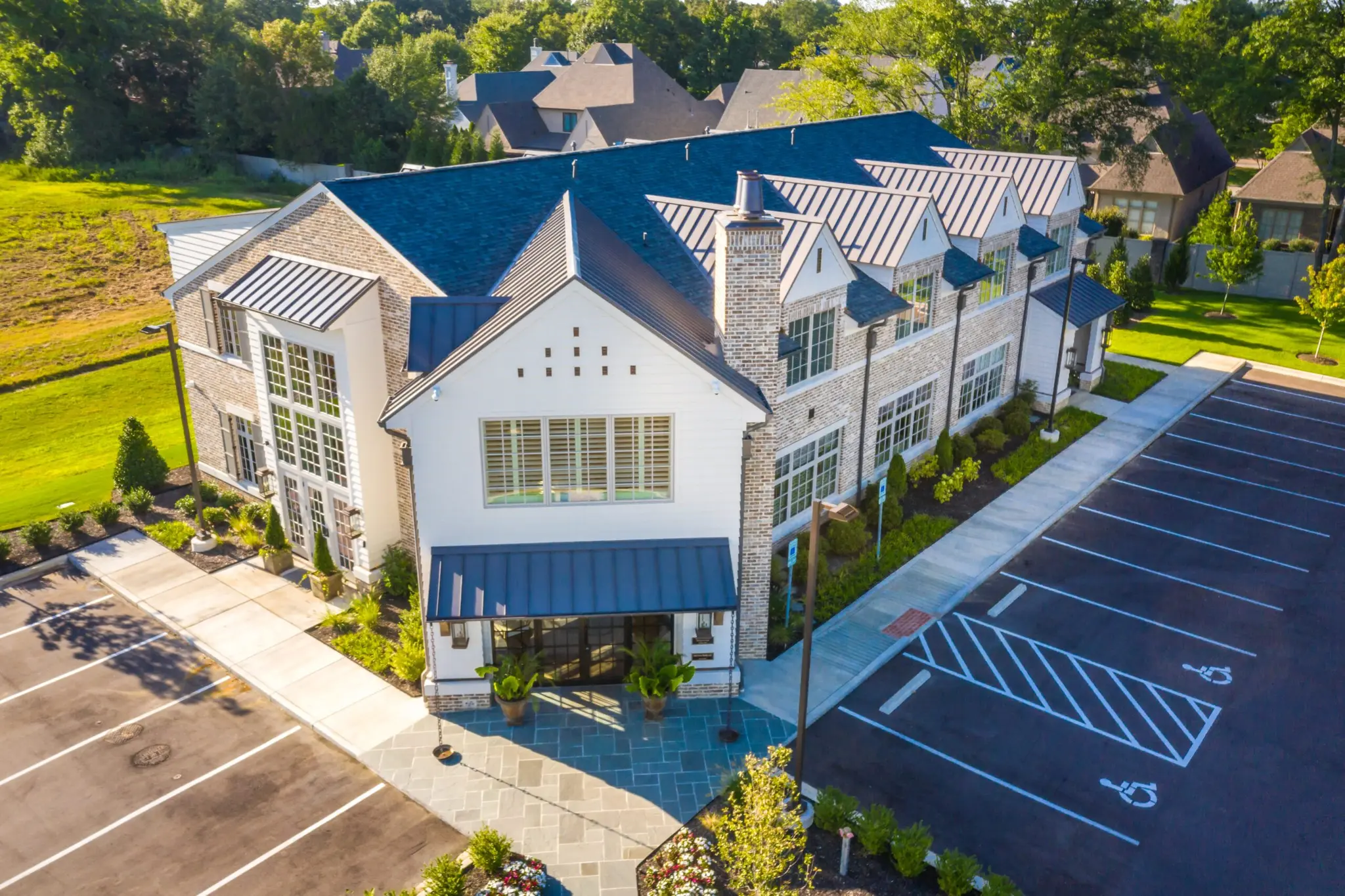Overview of exterior of Magnolia Homes main office with stunning roof lines and blue stone!